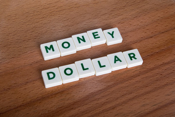 Money Euro Word with Green Letters on Wooden Background