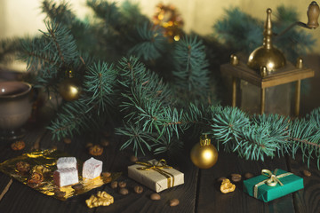 Coffee grinder, coffee beans and Christmas tree branch on a wooden table