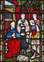Obraz na płótnie Canvas LONDON, GREAT BRITAIN - SEPTEMBER 19, 2017: The Parable of Talents on the stained glass in St Mary Abbot's church on Kensington High Street.