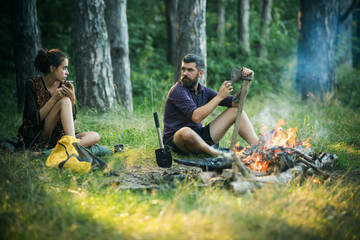 Man hipster sharpen axe