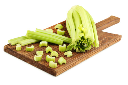 Celery on cutting board isolated on white