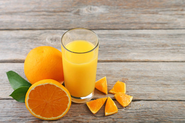 Glass of orange juice on wooden table