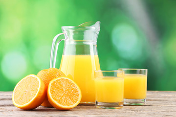 Fototapeta na wymiar Glass of orange juice on wooden table