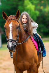 Fototapeta premium girl teenager rolls on her favorite horse, best friends.