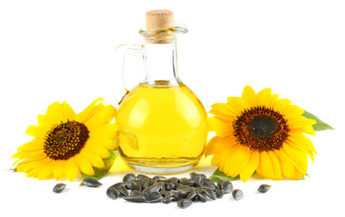 Sunflower oil in glass jug, seeds and flower isolated on white background