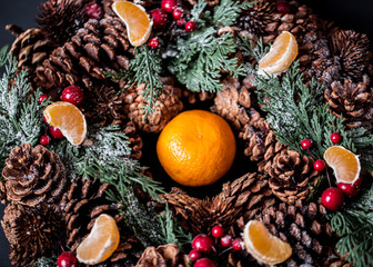 Obraz na płótnie Canvas Tangerines with christmas decoration on rustic wooden background. Tangerines with spruce. Christmas decoration. Copy space