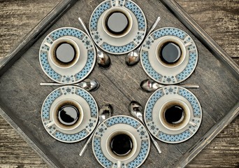 Cups with coffee,pattern and design concept-six cups of coffee on a wooden tray.