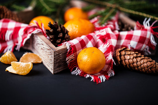 Tangerines with christmas decoration on rustic wooden background. Tangerines with spruce. Christmas decoration. Copy space