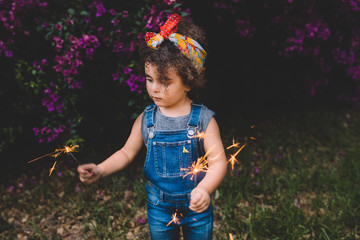 young girl playing with sparklers