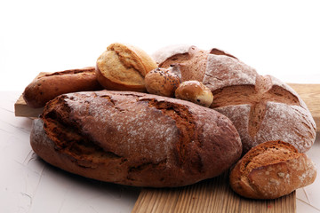 bakery concept with bread and bread rolls on white background.