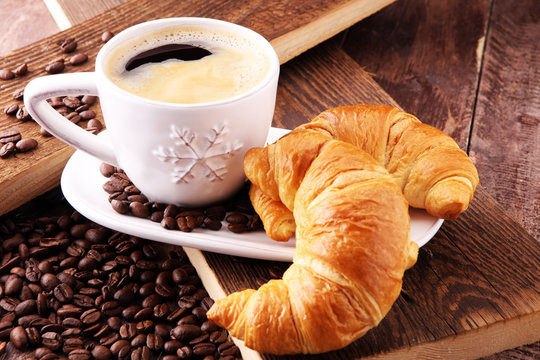 coffee and croissant with coffee beans. breakfast energy concept.