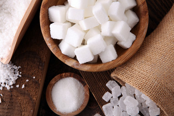 differnt kind of sugar in wooden bowl and spoon.