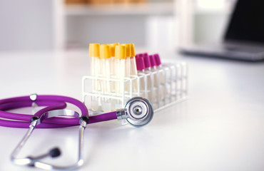 stethoscope near medical tubes on white background