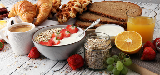 Breakfast served with coffee, orange juice, croissants, cereals and fruits. Balanced diet