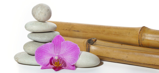 Set for spa with bamboo, stones, folded pyramid and orchid flower