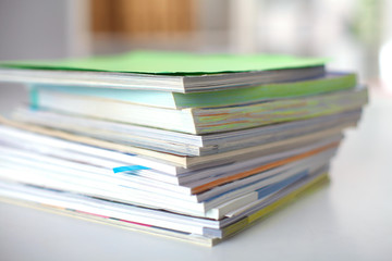 close up of stack of papers on white background