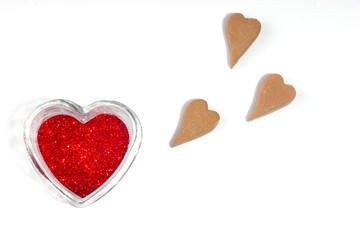 Red heart from spangles on white background