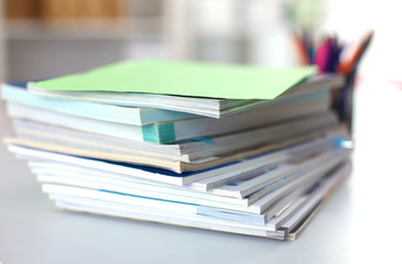 close up of stack of papers on white background
