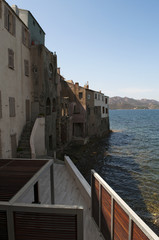 Fototapeta na wymiar Corsica, 29/08/2017: lo skyline di Saint-Florent (San Fiorenzo), popolare villaggio di pescatori sulla costa ovest dell'Alta Corsica, chiamato la Saint-Tropez corsa
