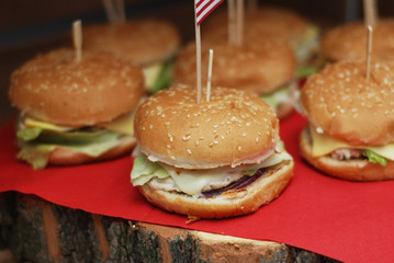 Close-up of Home Made tasty Burgers on Wooden Table and red Napkin.