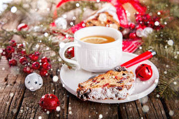 Dresdnen Stollen is a Traditional German Cake with raisins on a light knitted background.Gift for Christmas.Vintage style.Fruit cake for the Holiday. German, European festive dessert.Drawn Snowfall