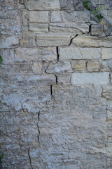 Texture. Brickwork with a crack. Ancient wall. Fragment. Vertical