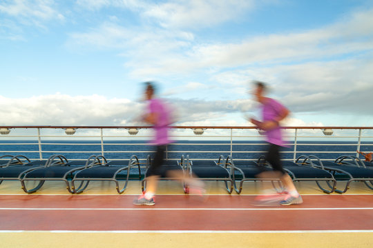 Blurred Joggers on cruise ship running track