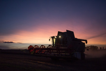 Combine harvester sunset