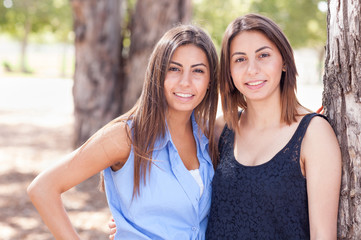 Two Beautiful Ethnic Twin Sisters Portrait Outdoors.