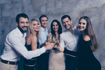 Best six friends in formal wear celebrating new years corporate party, drinking together, looking at camera, standing over grey background