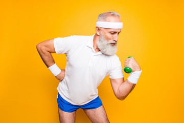 Body care, hobby, weight loss lifestyle. Cool grandpa with confident grimace exercising holding...