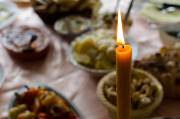Candle on the table with food for orthodox ceremeny