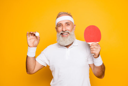 Competetive emotional cool active goofy comic grey haired grandpa with humor grimace and beaming grin, with table tennis equipment. Healthcare, weight loss, bodycare lifestyle
