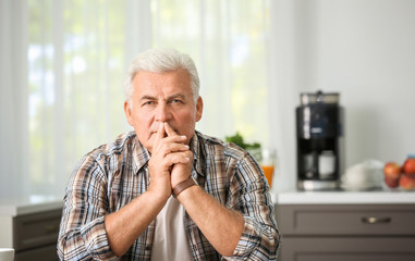 Handsome mature man in kitchen