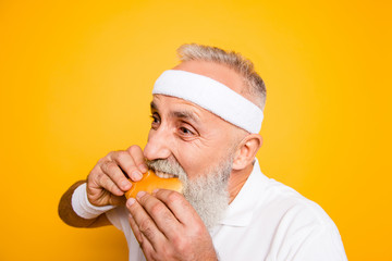 Weightloss, healthcare, gym, strength, regime, challenge. Close up of modern athlete cool grey haired pensioner grandpa hold yummy tasty delicious heavy grossy sandwich, destroys it