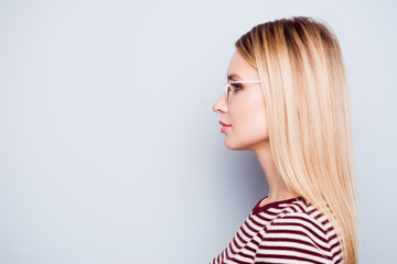 Close up side-view profile portrait of perfect serious woman in casual outfit wearing glasses...