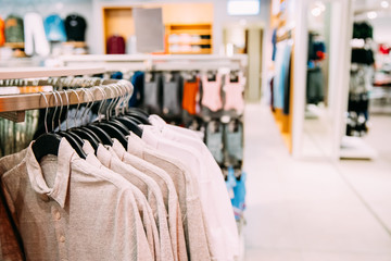 Many One-colour Polo Shirt On Hanger In Store Of Shopping Center