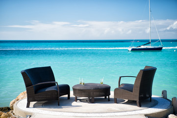 Armchairs and table on tropical beach in st johns, antigua - obrazy, fototapety, plakaty