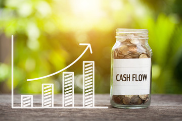 Cash Flow Word With Coin In Glass Jar and graph up. Financial Concept - obrazy, fototapety, plakaty