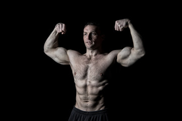 Obraz na płótnie Canvas Bodybuilder showing muscles, biceps and triceps