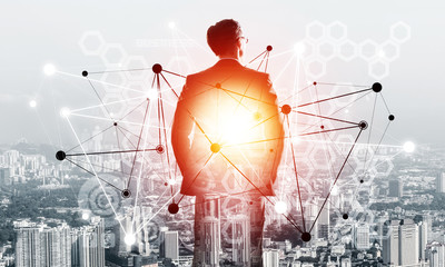 Concept of business success and control with confident boss against cityscape background