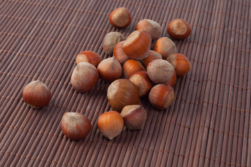 Hazelnuts on a wooden mat