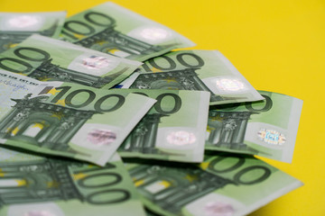 Obraz na płótnie Canvas Euro banknotes, hundred euro bills in a small pile of money