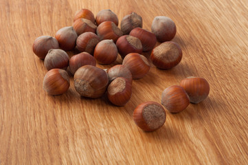 Hazelnuts on a wooden background