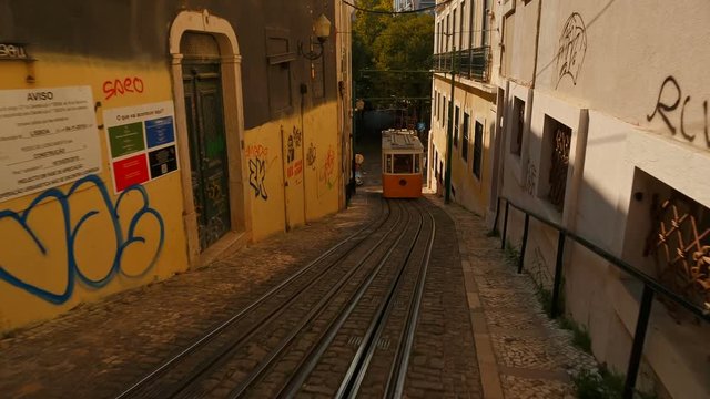 A POV descent towards Largo da Anunciada square in Lisbon, Portugal to meet the Elevador do Lavra funicular tram elevator, also known as Ascensor do Lavra.