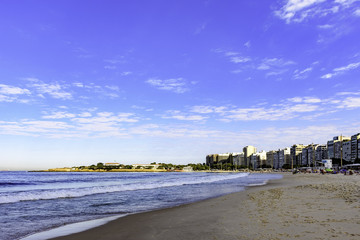 View of famous Copacabana beach with sea, buildings and fortress at Rio de Janeiro