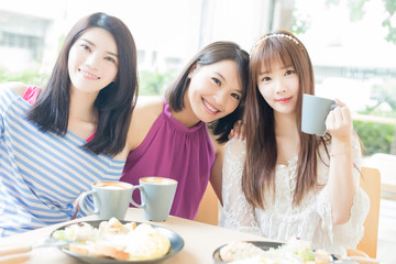 happy woman friends in restaurant