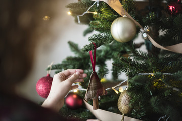 People decorating Christmas tree