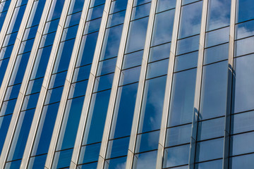Clouds Reflected in Windows of Modern Office Building..