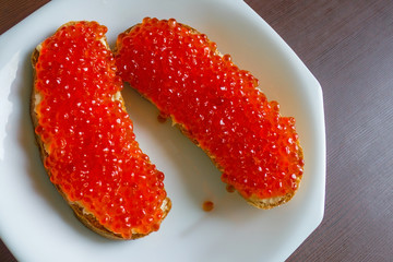 Two sandwiches with salmon caviar.